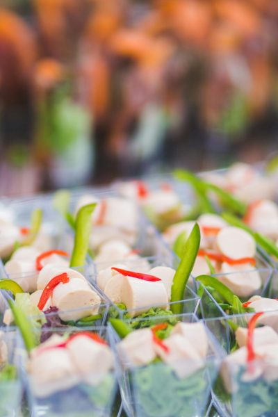 Vibrant assortment of vegetarian appetizers in small serving cups, perfect for parties and events.