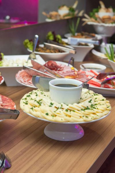 A delicious indoor buffet with assorted dishes on a wooden table.